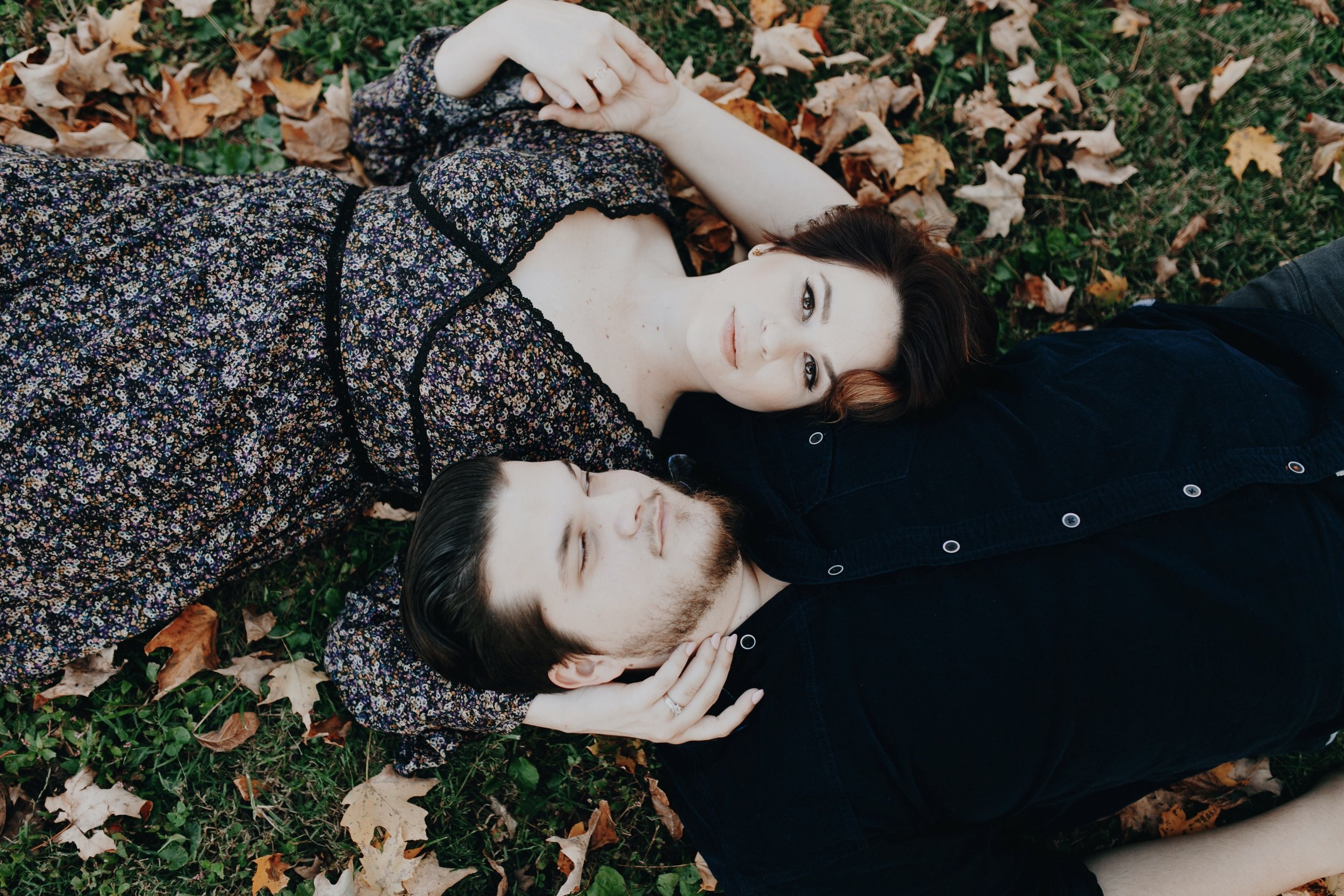 couple laying in fall leaves.jpg