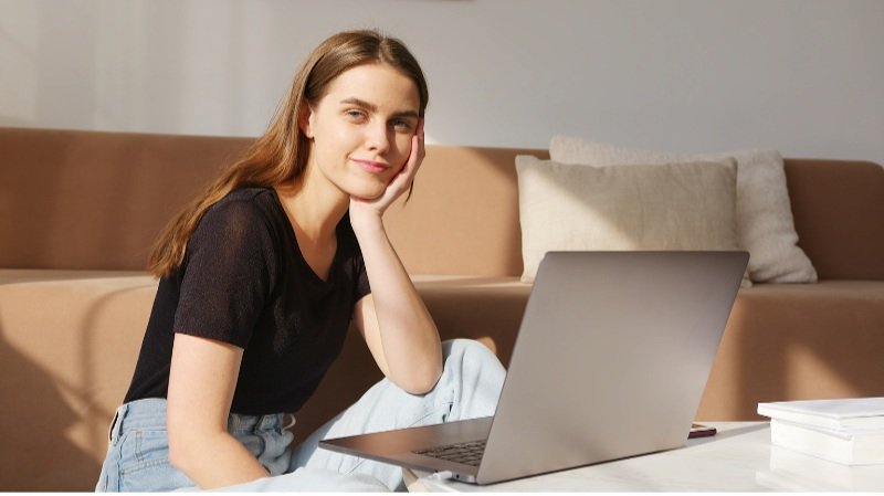 young woman working on laptop - how to invest in your 20's